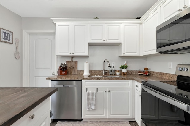 kitchen featuring white cabinets, sink, and stainless steel appliances