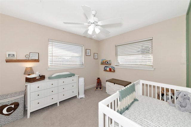 bedroom featuring light colored carpet and ceiling fan