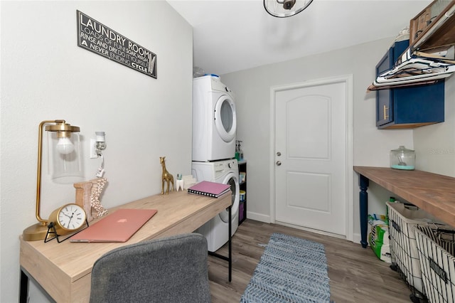 washroom with stacked washer / drying machine and wood-type flooring