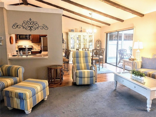 carpeted living room featuring lofted ceiling with beams and sink