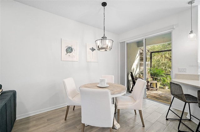 4008 Via Sienna Cir, Sarasota, FL 34243 - dining room featuring a chandelier, light wood finished floors, and baseboards