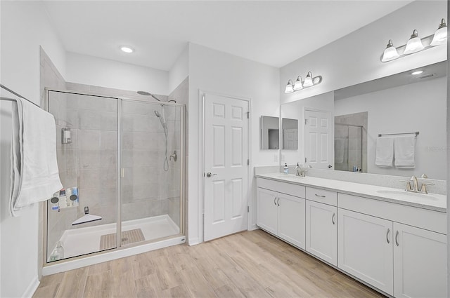 4008 Via Sienna Cir, Sarasota, FL 34243 - full bathroom with a shower stall, double vanity, and wood finished floors