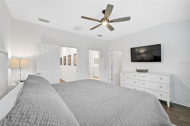 bedroom with ensuite bathroom, ceiling fan, dark hardwood / wood-style floors, and vaulted ceiling