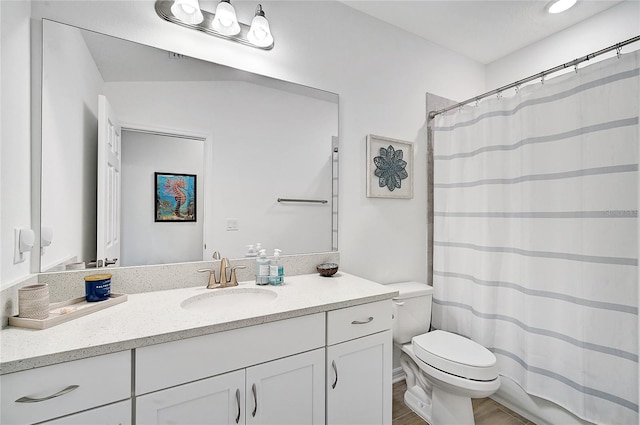 bathroom with a shower with shower curtain, wood-type flooring, vanity, and toilet