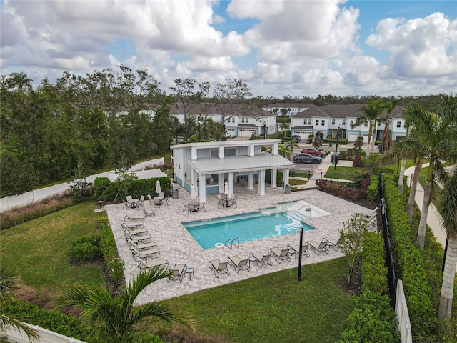 view of swimming pool featuring a patio area and a yard