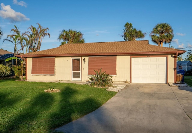 ranch-style house with a garage and a front lawn