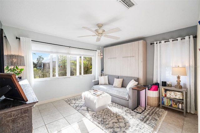 living room with ceiling fan and light tile patterned flooring