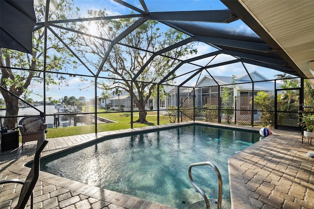 view of pool with a patio, a water view, and glass enclosure