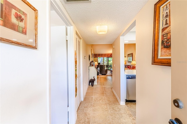 hallway featuring a textured ceiling