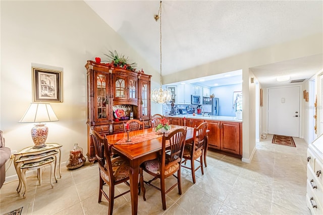 tiled dining area with high vaulted ceiling