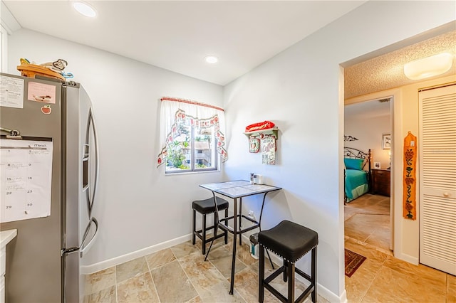 kitchen featuring stainless steel refrigerator with ice dispenser