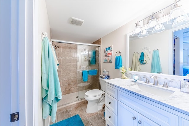 bathroom featuring walk in shower, vanity, and toilet