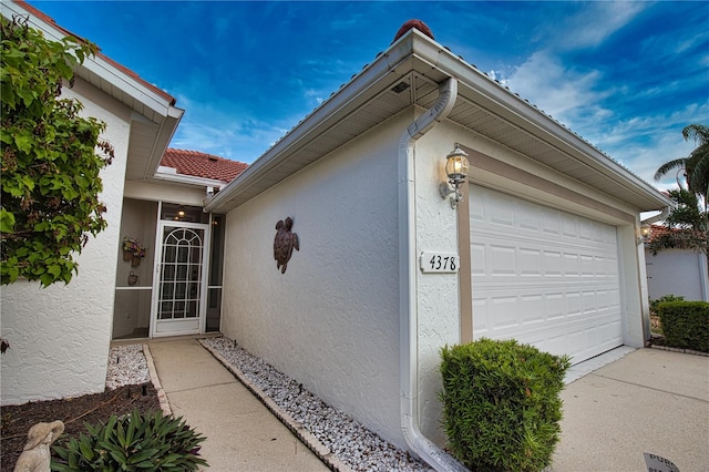 view of exterior entry with a garage