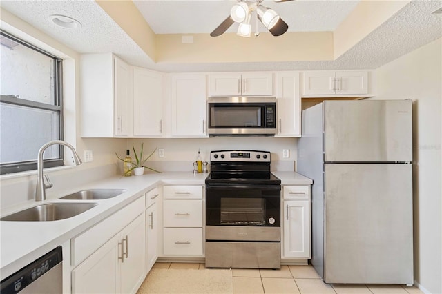 kitchen featuring white cabinetry, appliances with stainless steel finishes, sink, and a textured ceiling