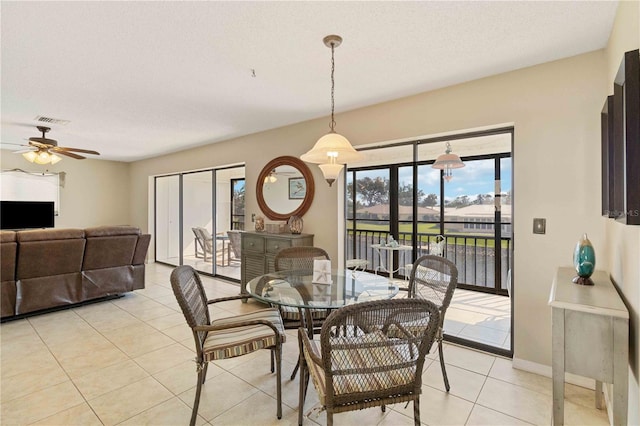 dining room with ceiling fan, a textured ceiling, and light tile patterned floors