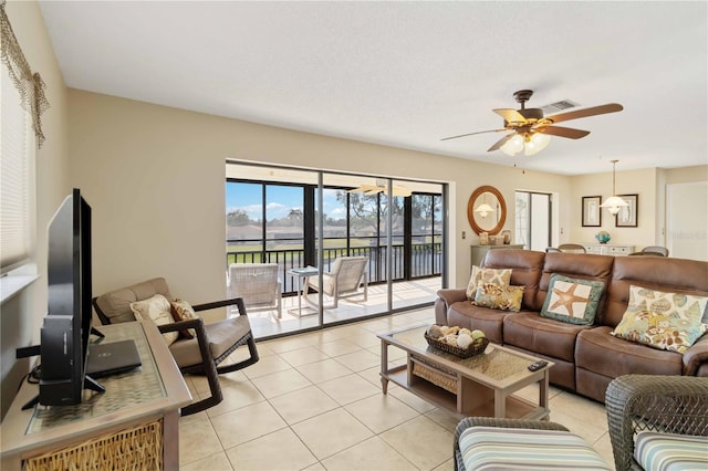 living room featuring ceiling fan and light tile patterned floors