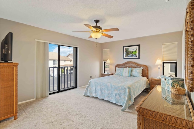 bedroom featuring ceiling fan, a textured ceiling, carpet flooring, and access to outside