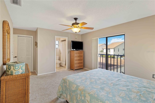 carpeted bedroom with access to outside, a textured ceiling, ensuite bathroom, ceiling fan, and a closet