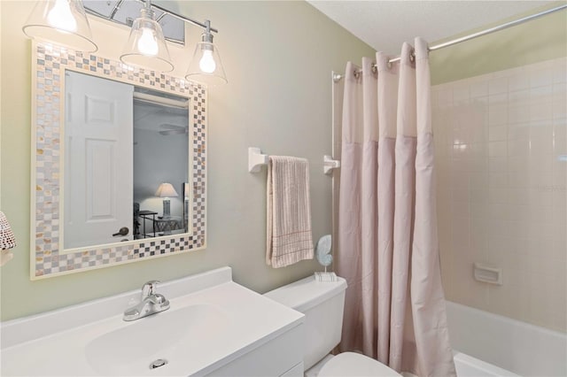 full bathroom featuring toilet, shower / tub combo, vanity, and a textured ceiling