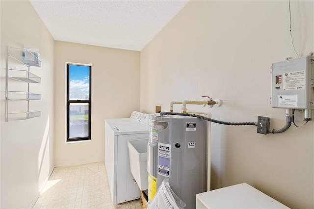 laundry room featuring water heater, a textured ceiling, and independent washer and dryer