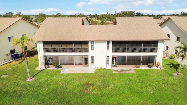 rear view of property with a patio area, a lawn, and a balcony