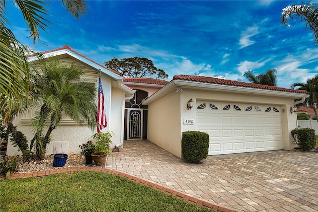 mediterranean / spanish-style home with a garage