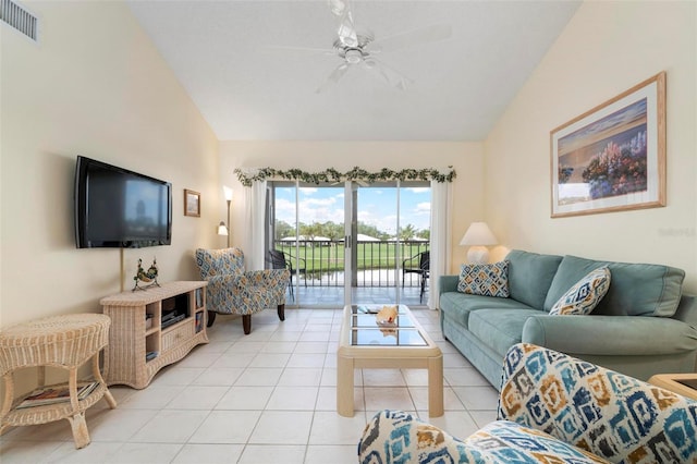 living room featuring ceiling fan, lofted ceiling, and light tile patterned floors