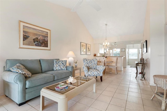 living room featuring ceiling fan with notable chandelier, light tile patterned flooring, and high vaulted ceiling