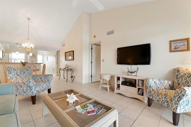 tiled living room featuring ceiling fan with notable chandelier and high vaulted ceiling