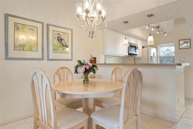 tiled dining area featuring a chandelier