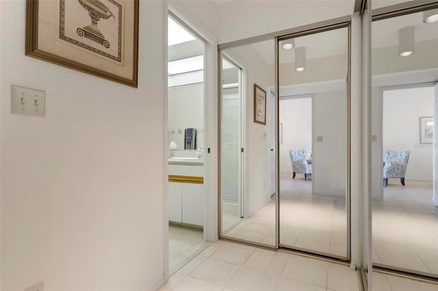 hall with light tile patterned floors