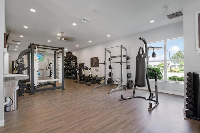 workout area with hardwood / wood-style floors and ceiling fan