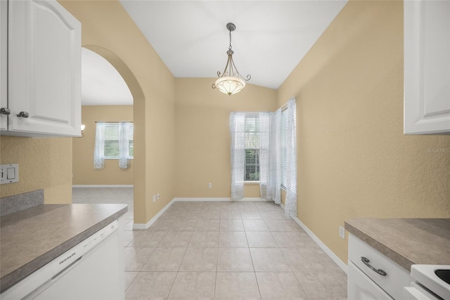 kitchen with dishwasher, light tile patterned floors, vaulted ceiling, decorative light fixtures, and white cabinets