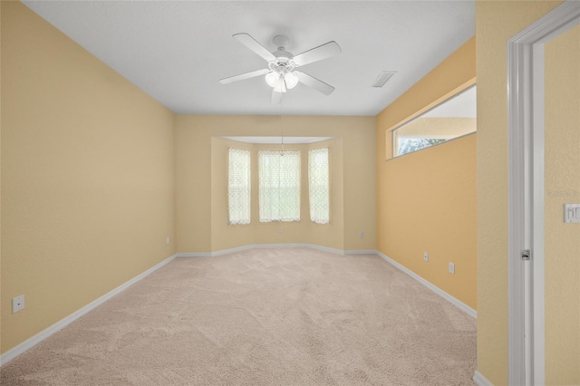 empty room with light carpet and ceiling fan