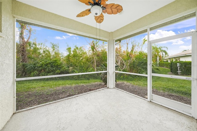 unfurnished sunroom with ceiling fan