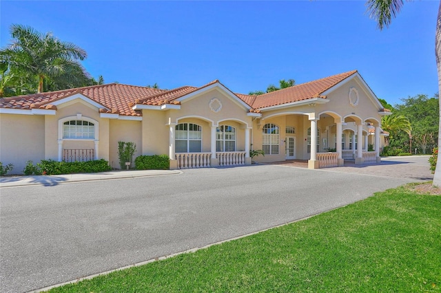 mediterranean / spanish house with covered porch