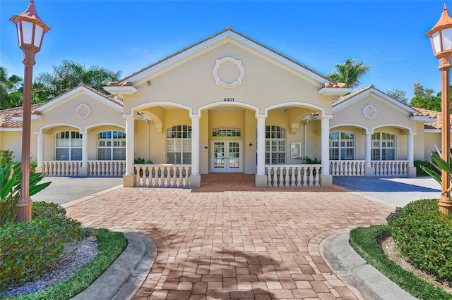 view of front of house with a porch and french doors