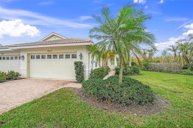 view of front of property with a front yard and a garage