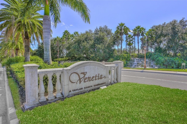 community / neighborhood sign with a lawn