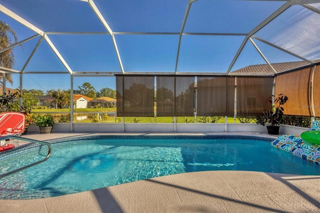 view of pool with glass enclosure and a patio area