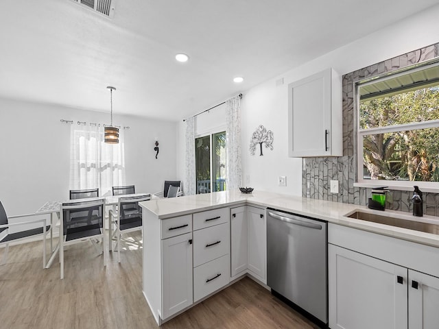 kitchen with dishwasher, white cabinetry, sink, and wood-type flooring