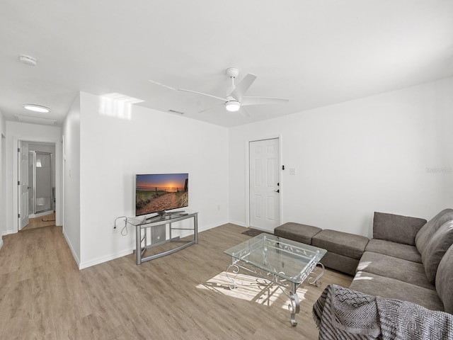 living room featuring ceiling fan and light hardwood / wood-style flooring