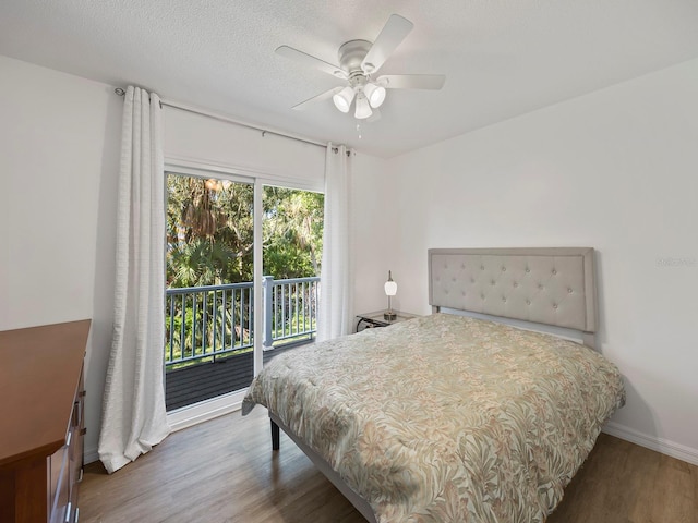 bedroom featuring hardwood / wood-style floors, access to exterior, and ceiling fan