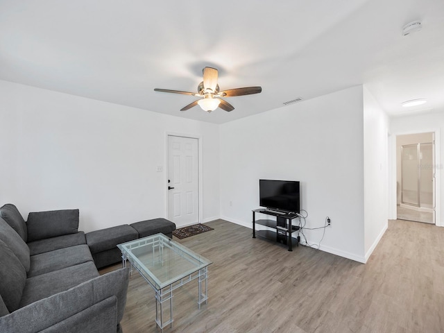 living room with hardwood / wood-style flooring and ceiling fan