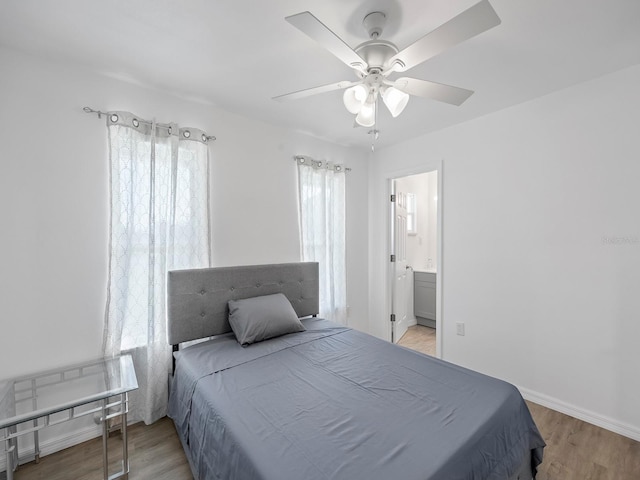 bedroom featuring connected bathroom, ceiling fan, and light hardwood / wood-style flooring