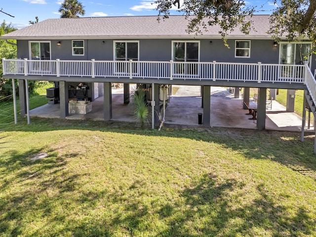 back of property with a patio and a yard