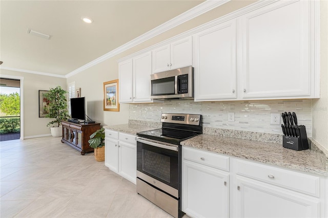 kitchen with white cabinetry, light stone counters, backsplash, crown molding, and appliances with stainless steel finishes