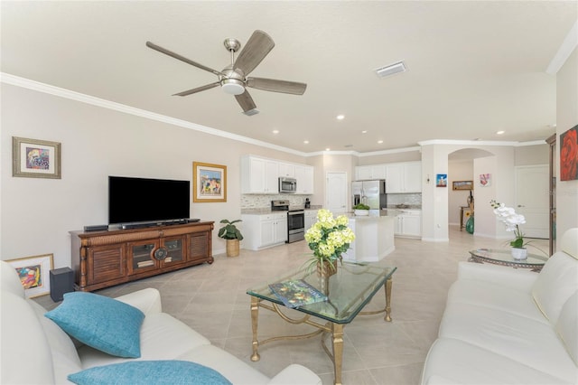 tiled living room featuring ceiling fan and ornamental molding