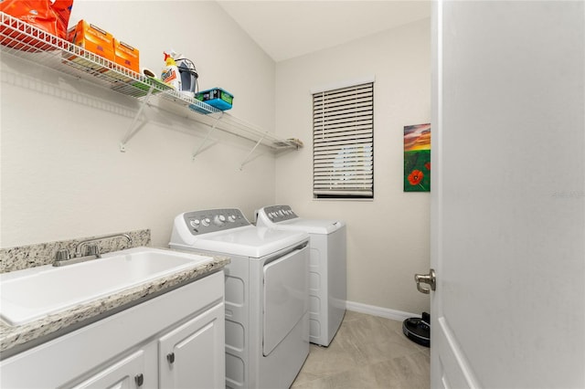 laundry room with cabinets, sink, and washing machine and clothes dryer