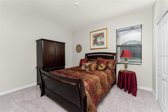 bedroom featuring a closet and light colored carpet